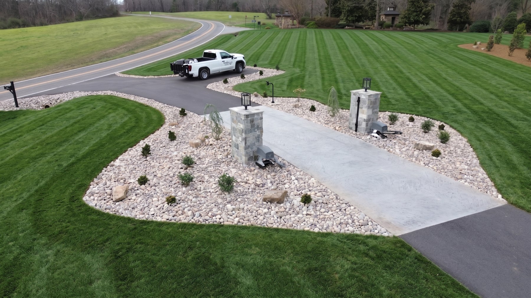 Landscape beds with foundational plantings, River Jack and accent boulders